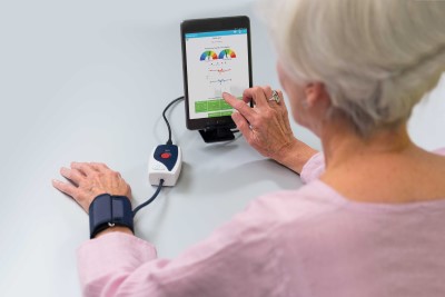 Older woman uses virtual care monitor